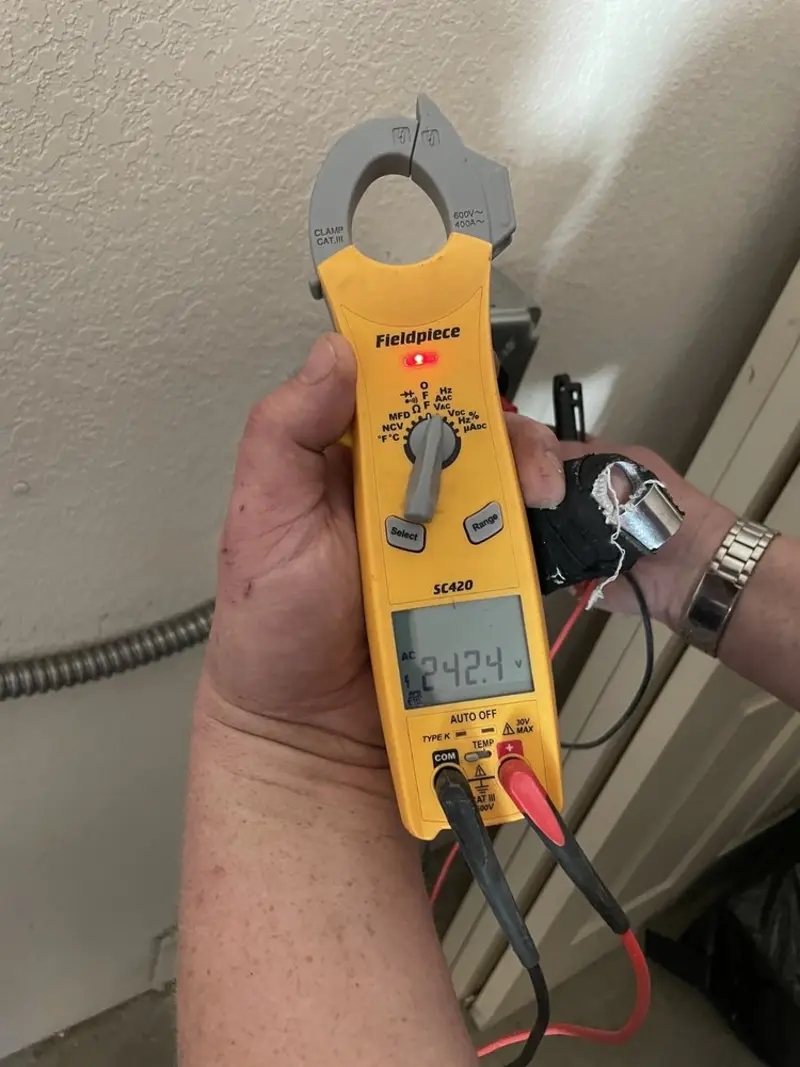 Voltage testing with clamp meter during Electrical Installation Services in Tazewell